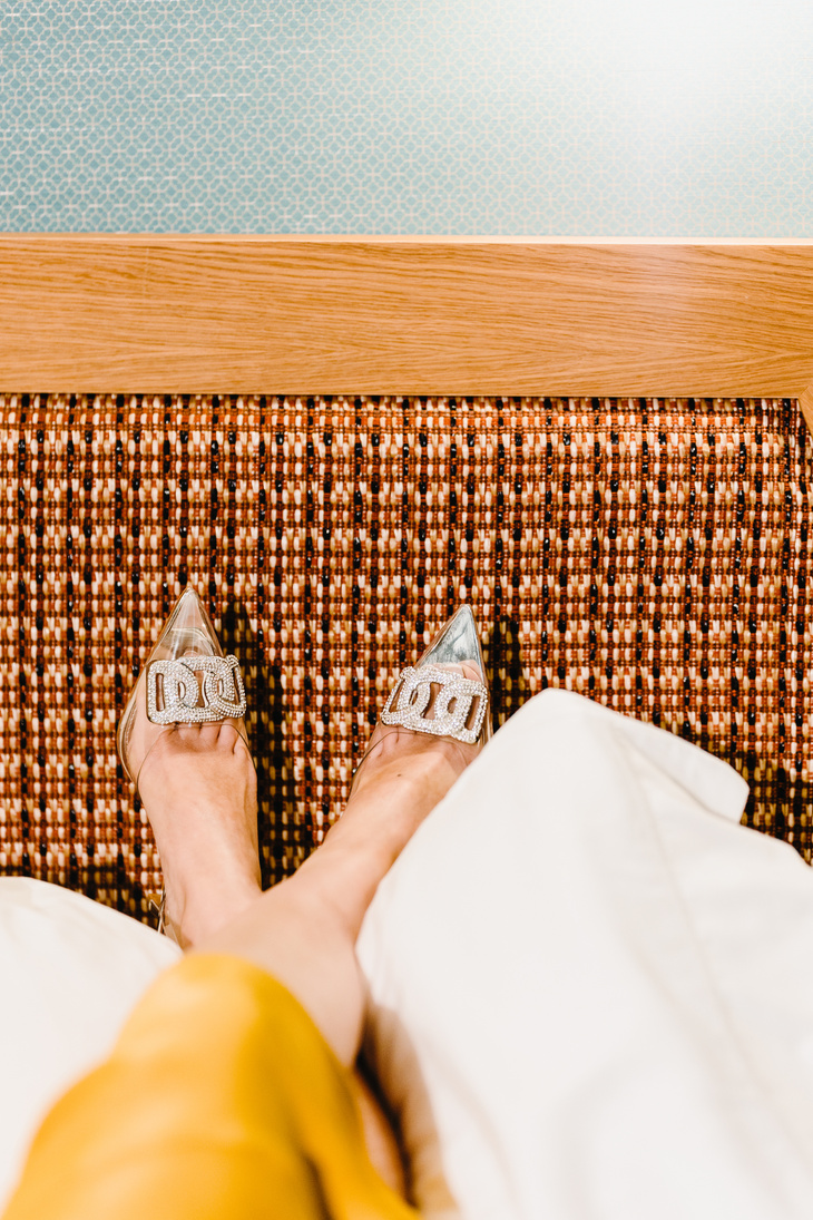 Neo-Opulence Person Wearing Heels in Bed